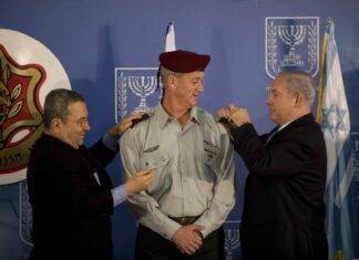 Israeli Prime Minister Benjamin Netanyahu, right, and Defense Minister Ehud Barak, left, take part in a ceremony formally promoting Maj. Gen. Benny Gantz, center, to lieutenant general and making him the 20th chief of the general staff of the Israel Defense Forces Feb. 14, 2011, at the prime minister's office in Jerusalem. U.S. Chairman of the Joint Chiefs of Staff Navy Adm. Mike Mullen was among the guests in attendance. (U.S. Army photo by Staff Sgt. Teddy Wade/Released)