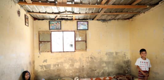 Sara and Bilal at their home in Hay el Gharbeh, an informal settlement in Southern Beirut. Their father, Tarek, cannot afford the basics for his four children: “Everything, from food to medicine, is difficult to buy this year. We have to live without basics”, he says.