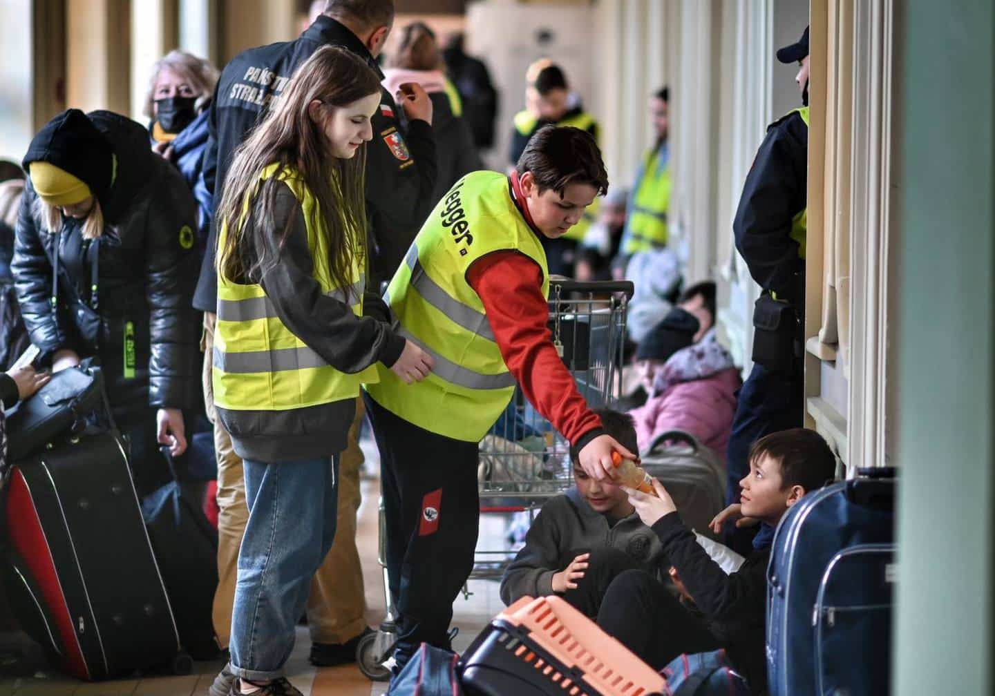 Un volontaire polonais aide un réfugié à la gare de Przemyśl.