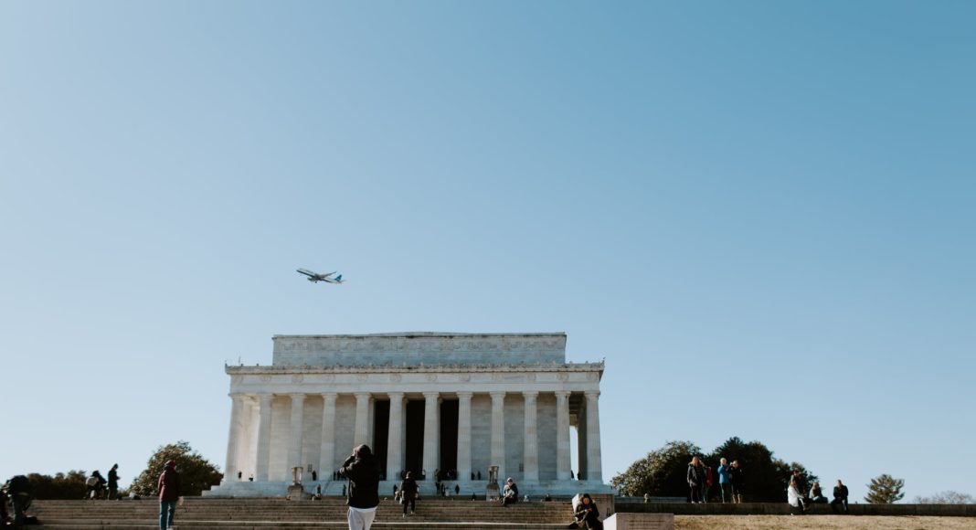 people walking on stairs near white concrete building