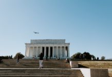 people walking on stairs near white concrete building