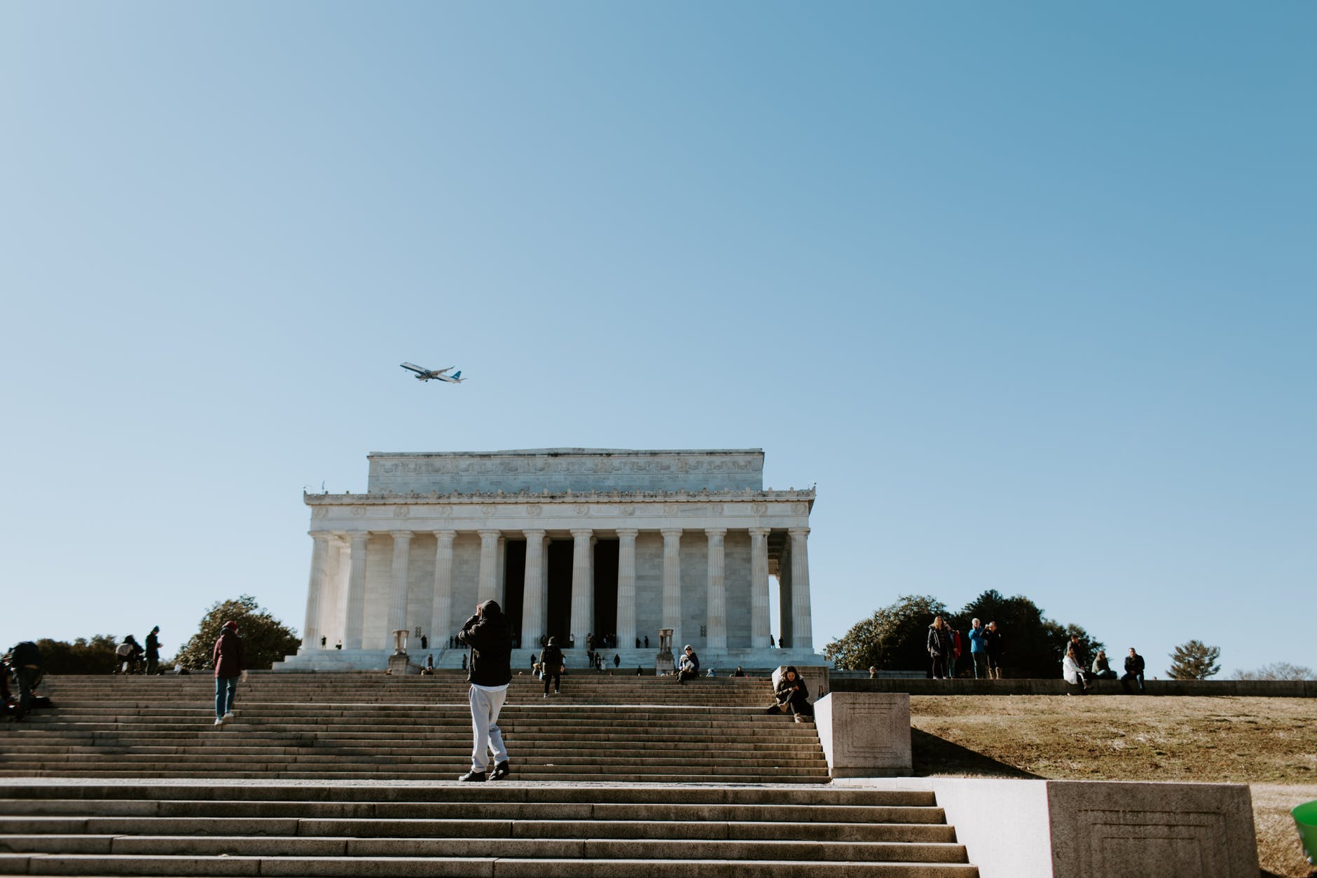 people walking on stairs near white concrete building
