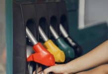 crop woman taking refueling pistol gun