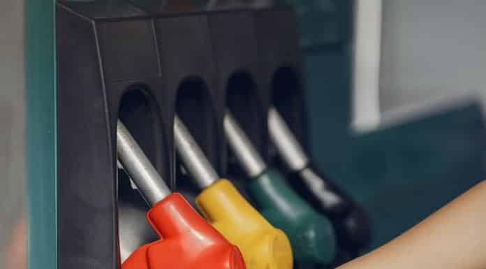 crop woman taking refueling pistol gun