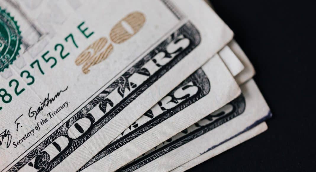 pile of american paper money on black surface