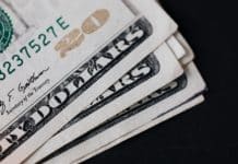 pile of american paper money on black surface