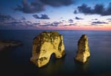brown rock formation on the sea