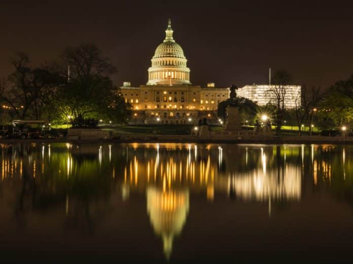 the us capitol white house near a lake at night