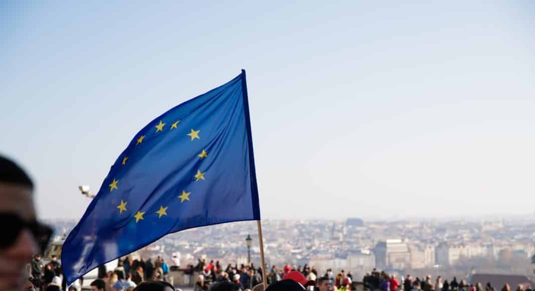 people on street with european union flag