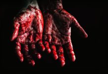person s hands covered with blood