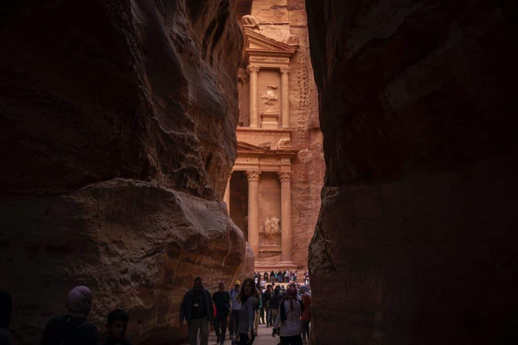 people walking near the rock formation