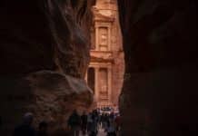 people walking near the rock formation