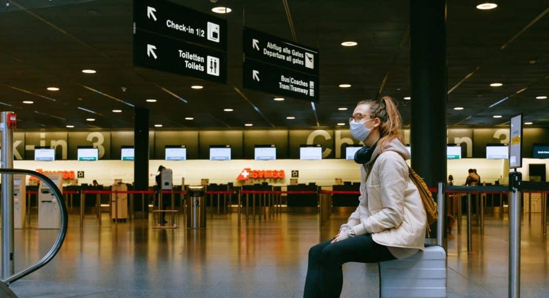woman sitting on luggage
