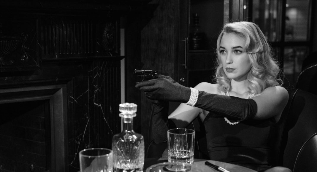 photo of an elegant woman pointing the gun