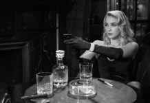 photo of an elegant woman pointing the gun