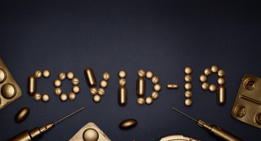 syringe and pills on blue background