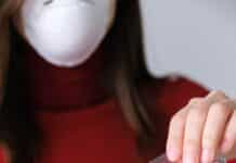 woman applying hand sanitizer