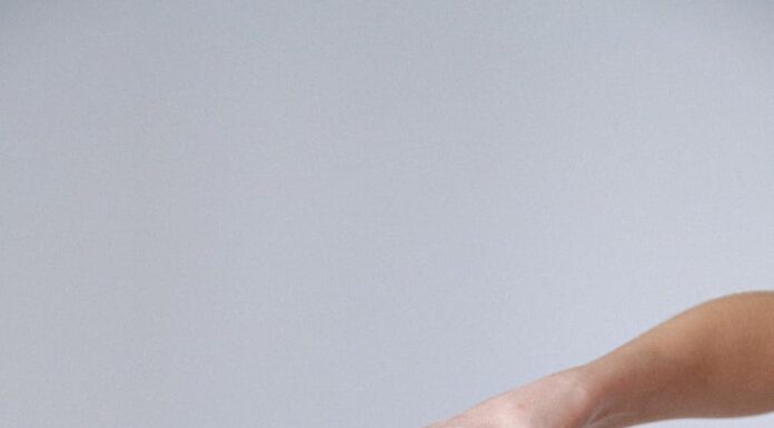 woman applying hand sanitizer
