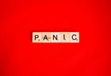 scrabbled tiles on red surface