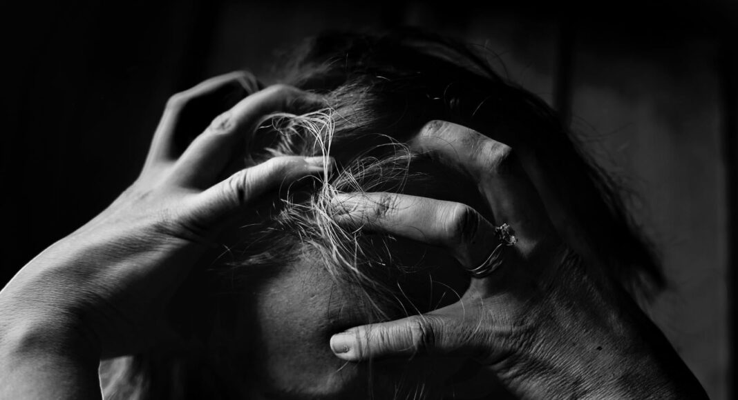 woman holding her head