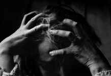 woman holding her head