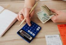 woman calculating money and receipts using a calculator