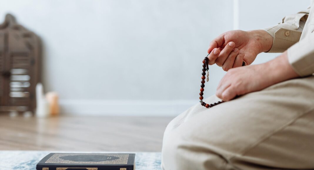 close up shot of person holding prayer beads