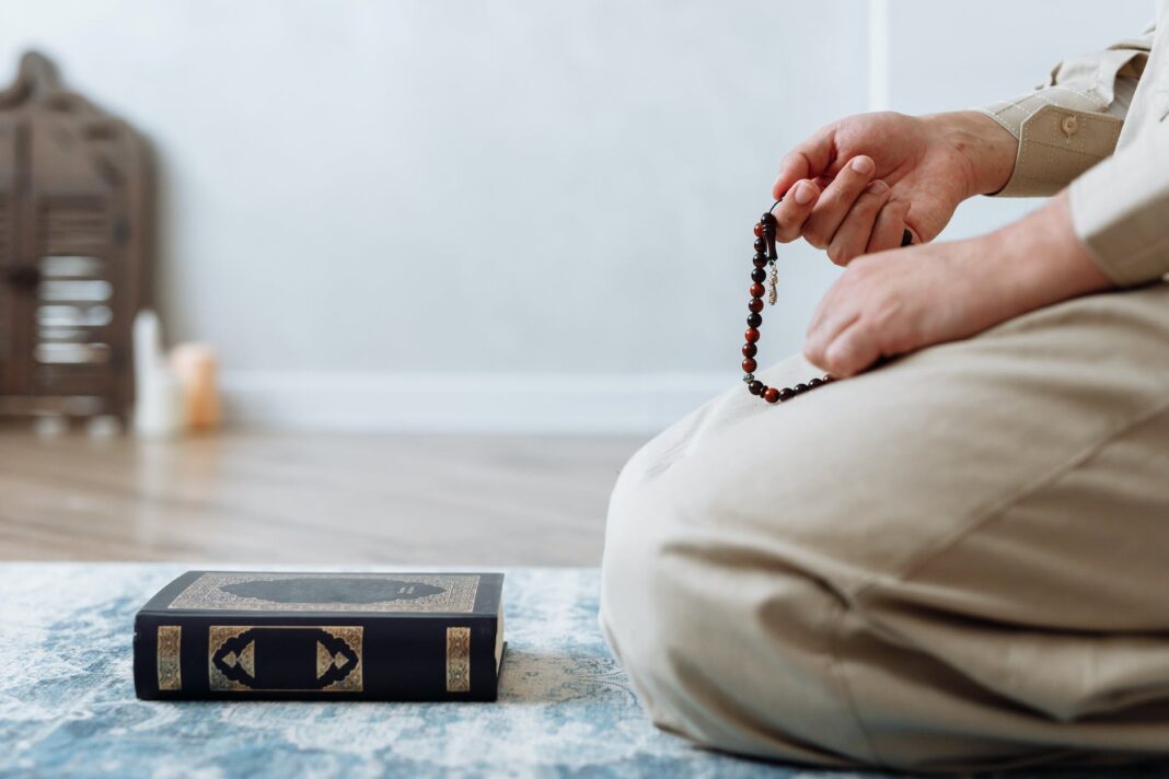 close up shot of person holding prayer beads