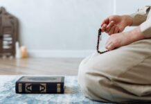 close up shot of person holding prayer beads