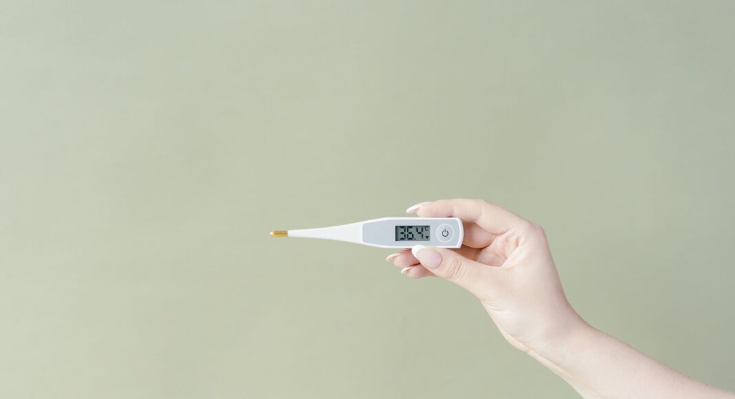 close up shot of a person holding a thermometer