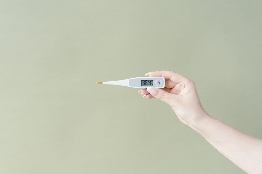 close up shot of a person holding a thermometer