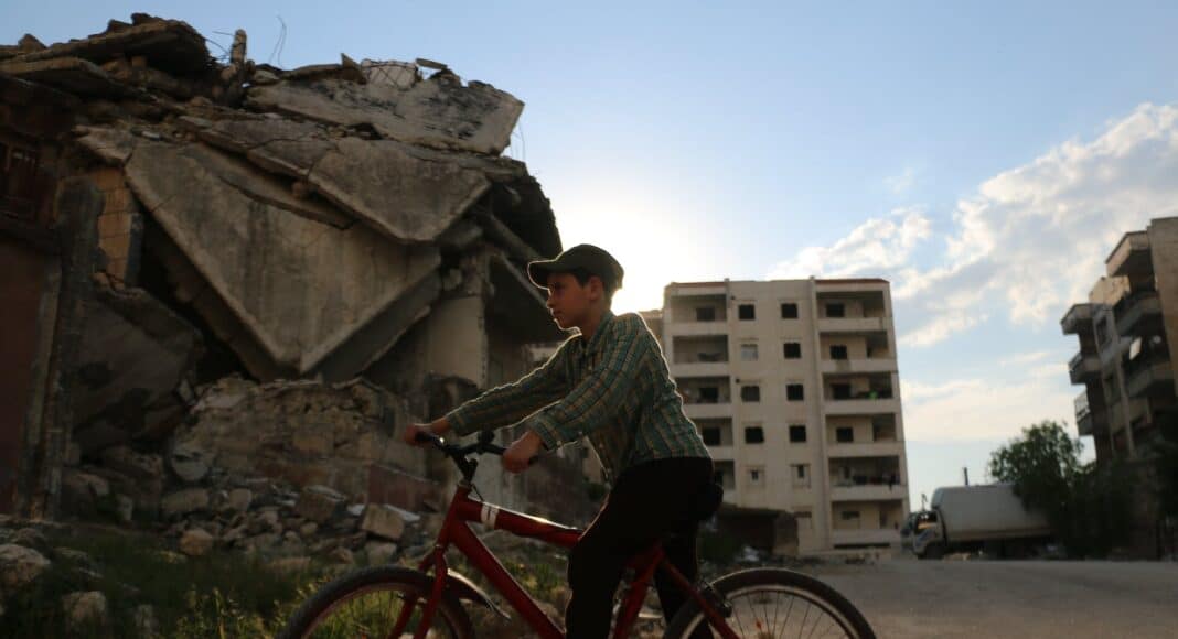 boy riding bicycle on street