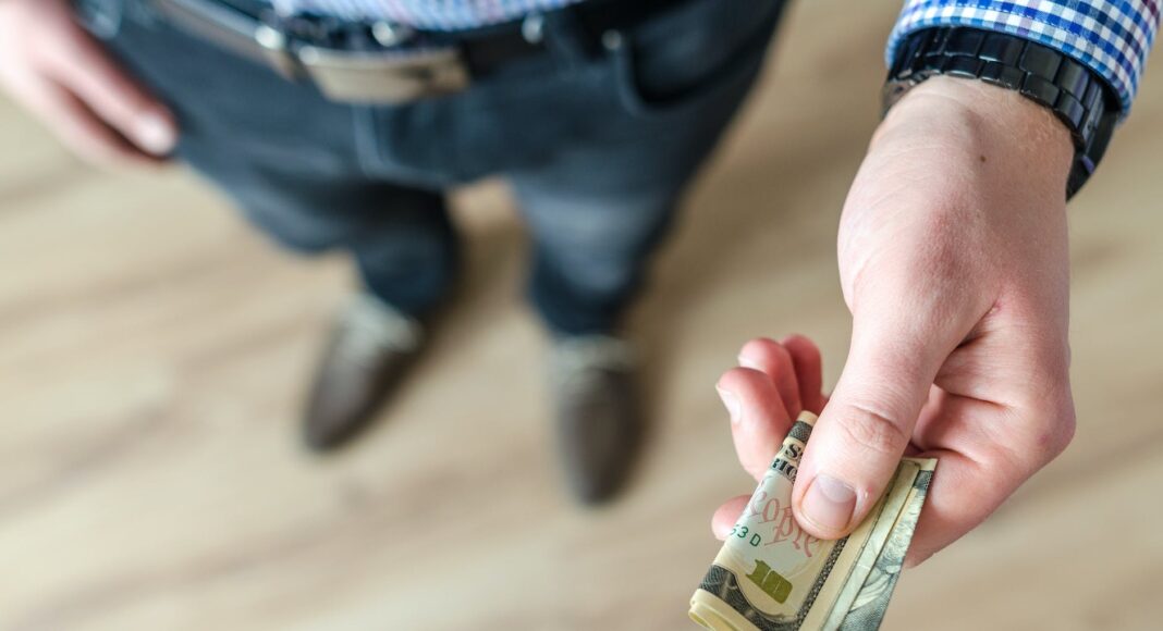 person holding banknote