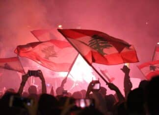 a crowd gathered in a concert waving flags