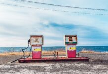 white and pink gasoline station near ocean