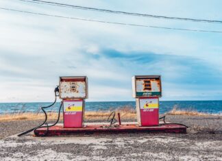 white and pink gasoline station near ocean