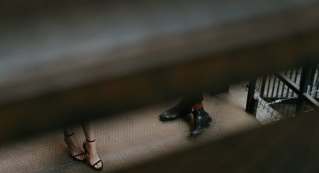 woman in black leather peep toe heeled shoes