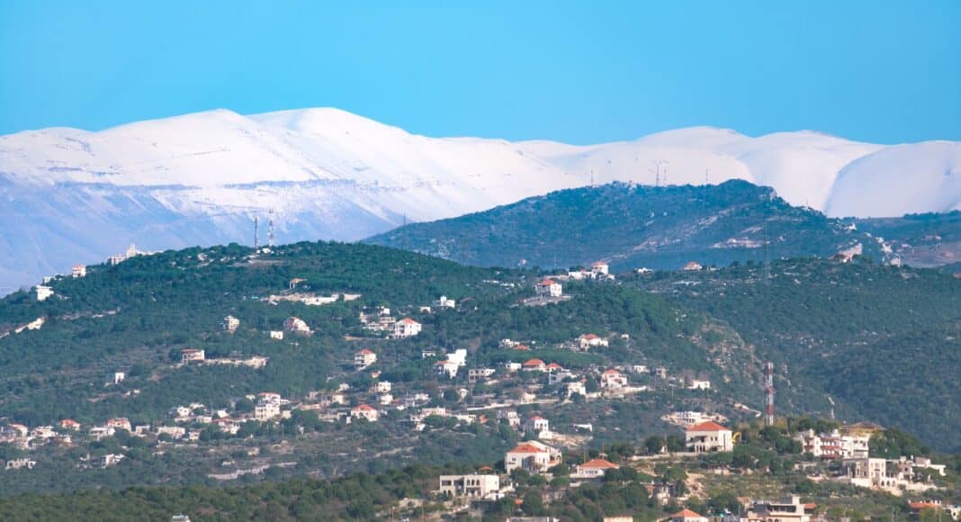 aerial photography of a village near mountains