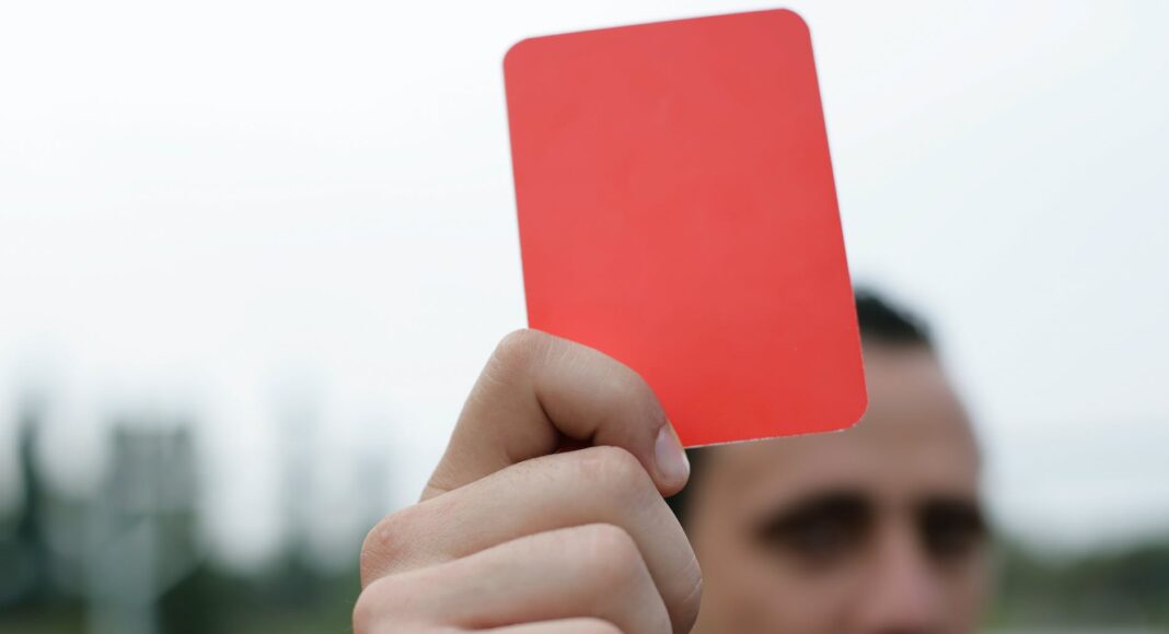person holding red card