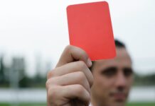 person holding red card