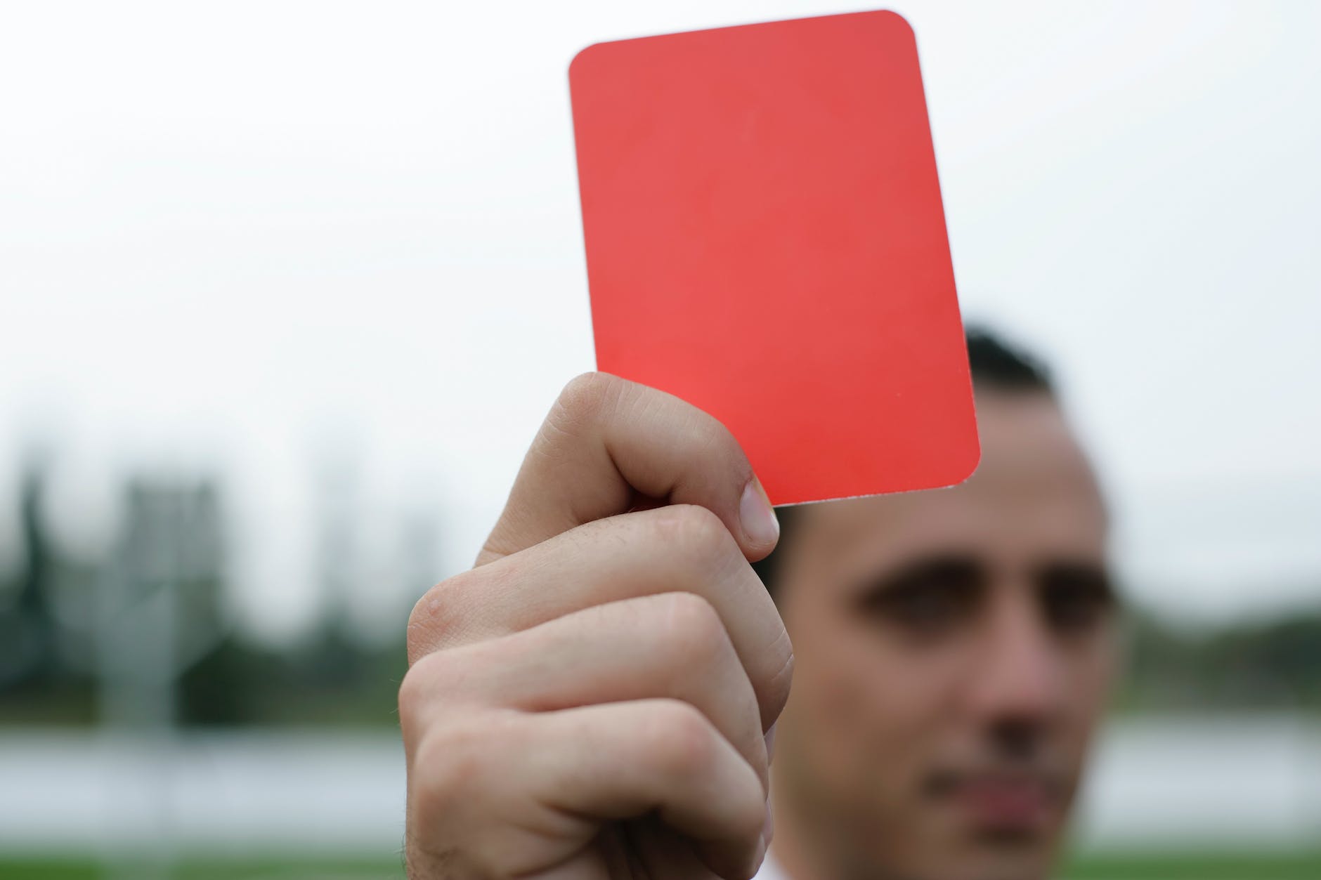 person holding red card