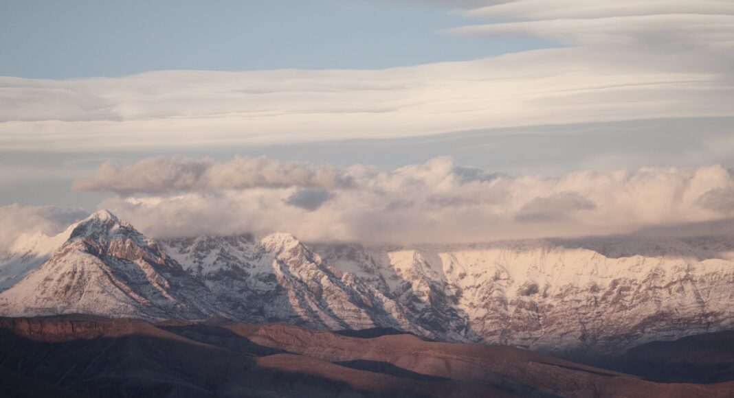 snow covered mountains under the cloudy sky