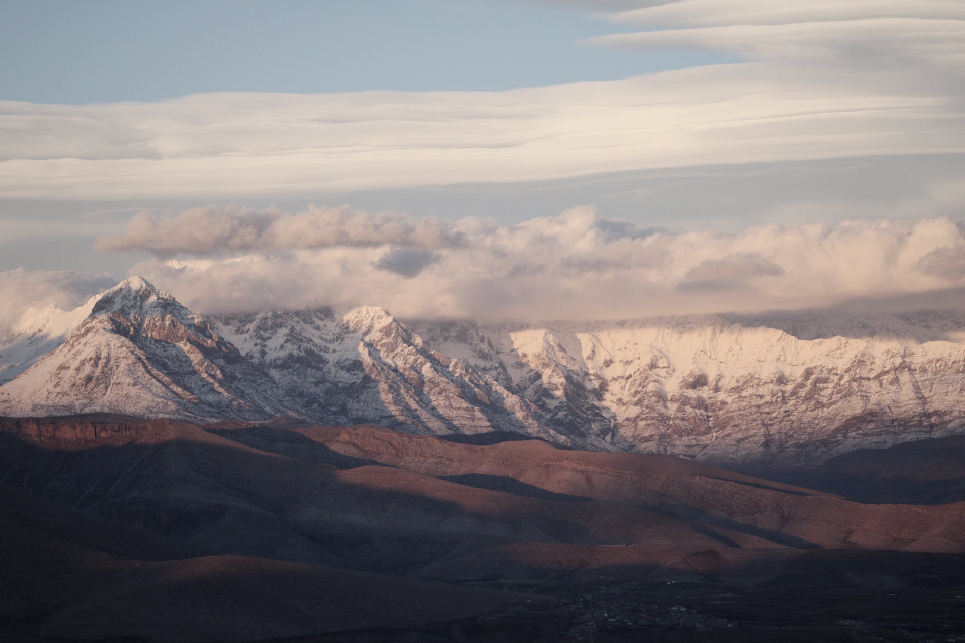 snow covered mountains under the cloudy sky