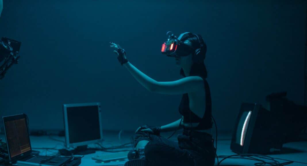 a woman in a tank top using a vr headset