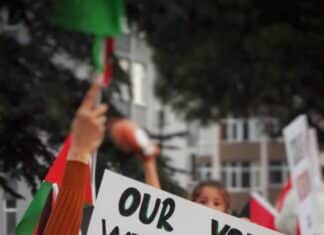 a sign that reads our voices will never be silenced israel