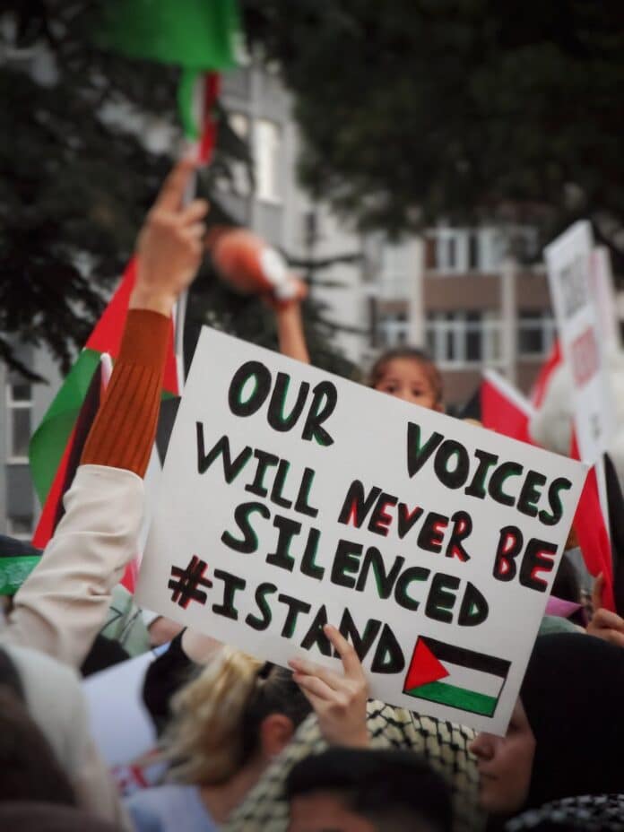 a sign that reads our voices will never be silenced israel