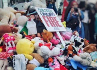 a pile of stuffed animals and a sign that says fire