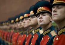 men in black and red cade hats and military uniform
