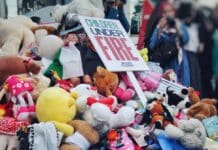 a pile of stuffed animals and a sign that says fire