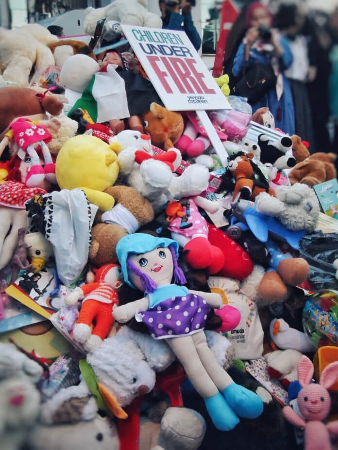a pile of stuffed animals and a sign that says fire